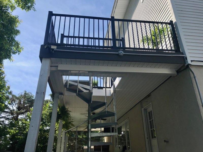 We installed a second-floor deck and railing, and installed this beautiful spiral staircase