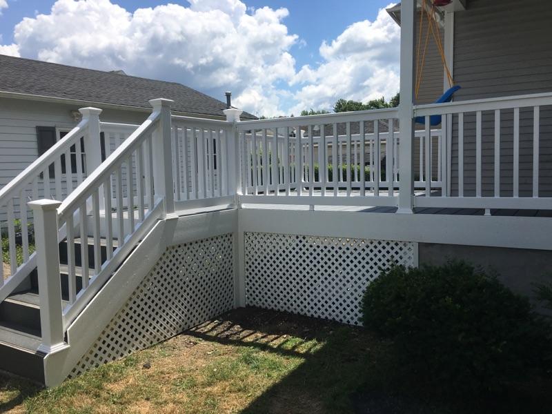 Installation of deck, railing and stairs - enhances curb appeal on this home