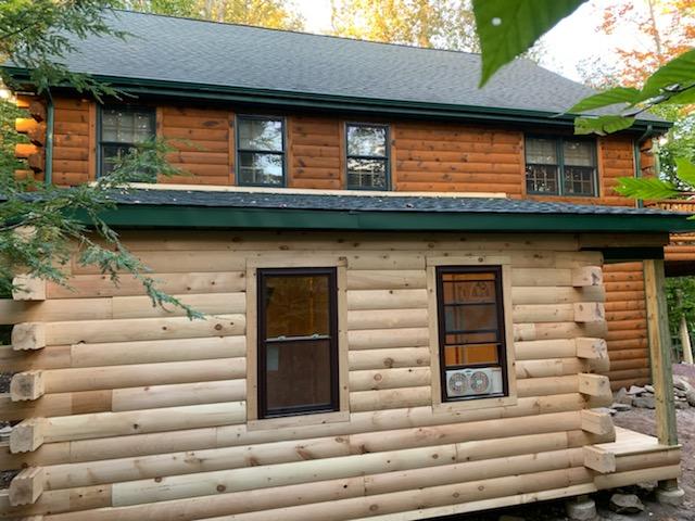 The stunning side view of the addition on the log cabin home